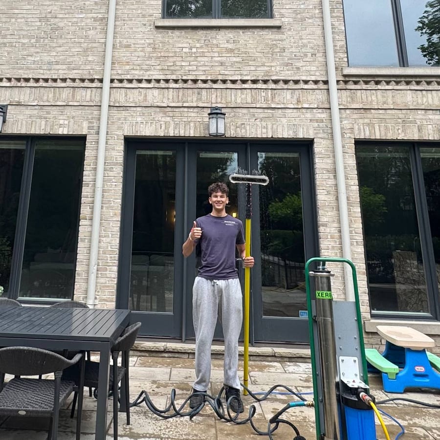Sevastian Vakulenko, owner of Seva's Services, with his water-fed pole and pure-water system at a North York home